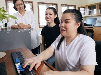 A person with disability working on a computer. 
