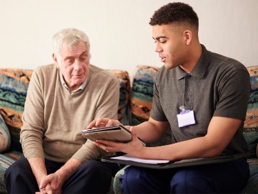A carer helping an older person. 
