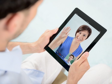 A person in a video call with an iPad. 