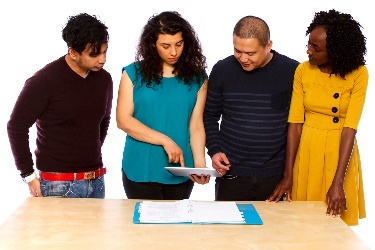 A group of people are discussing a document. 