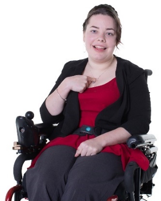 A person in a wheelchair pointing at themselves. 