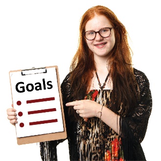 A young woman holding a list of goals. 