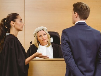 Two people talking to a judge. 