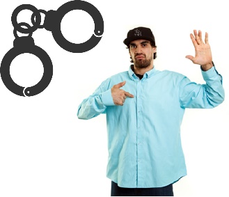 A man pointing at himself and a pair of handcuffs. 