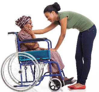 A woman helping a woman in a wheelchair. 